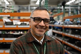 An S&C team member smiles at the camera