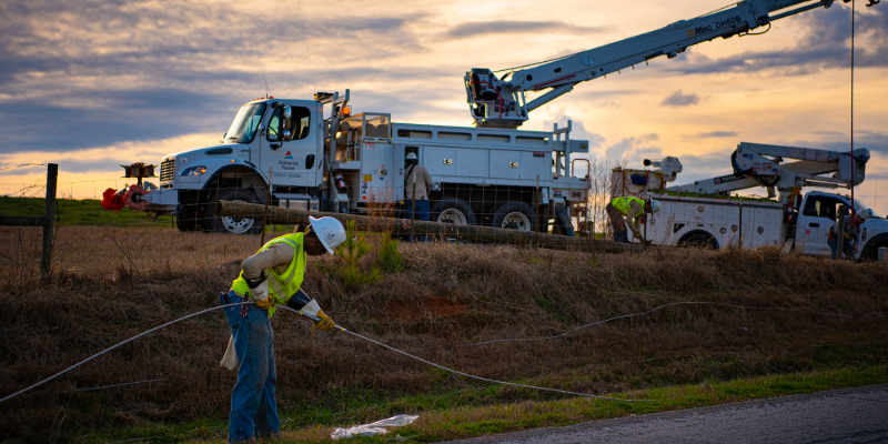 Alabama Power crews work to restore power in a rural area