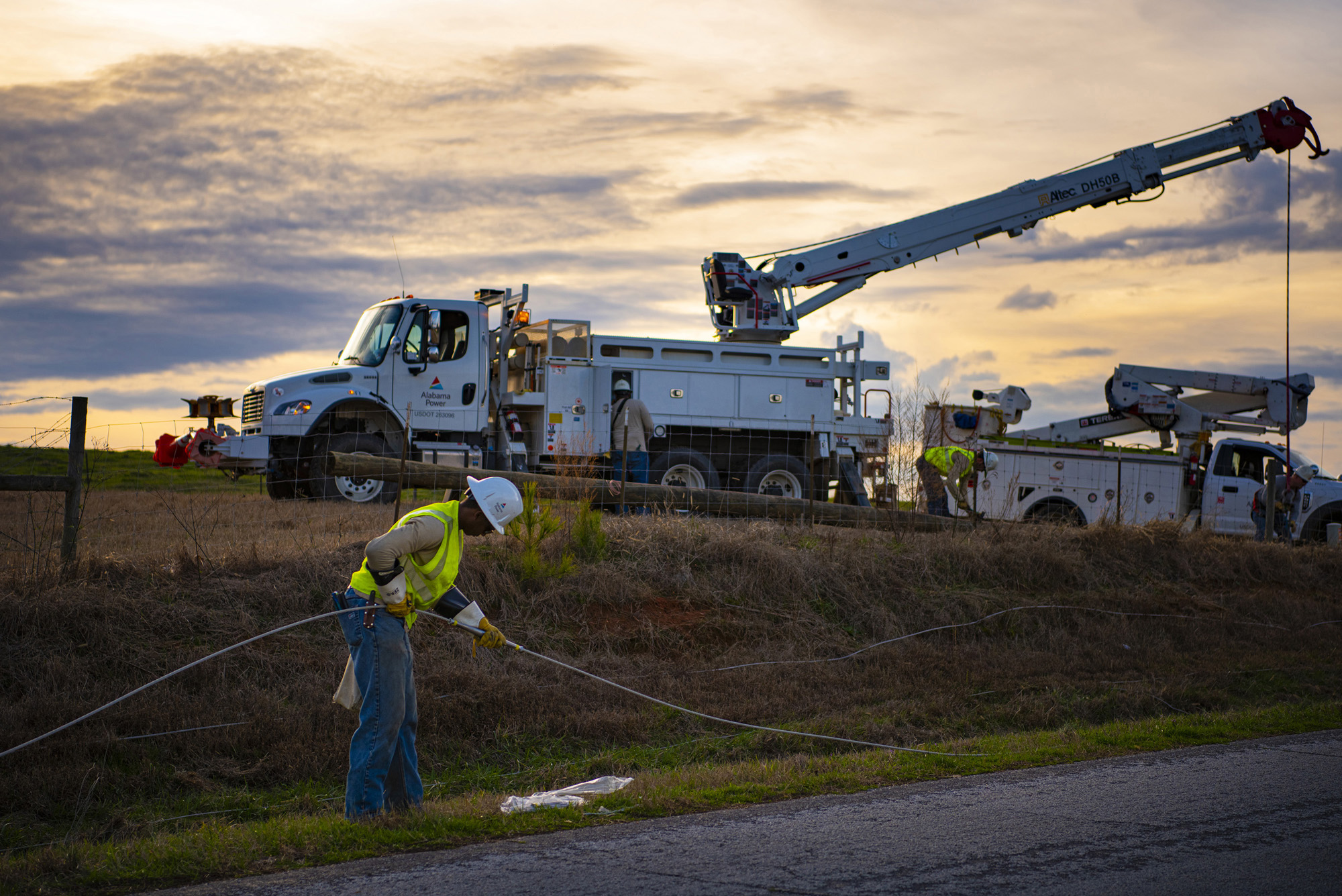 Alabama power crews work to restore power in a rural area