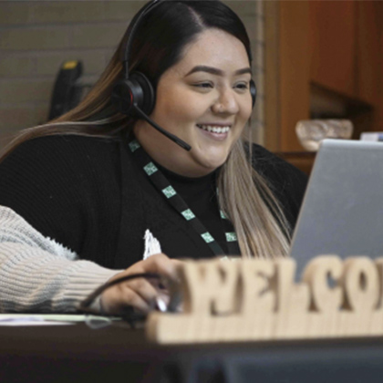 A team member welcomes visitors to S&C's Chicago campus. welcome, visitor desk, check-in, secretary, careers, job