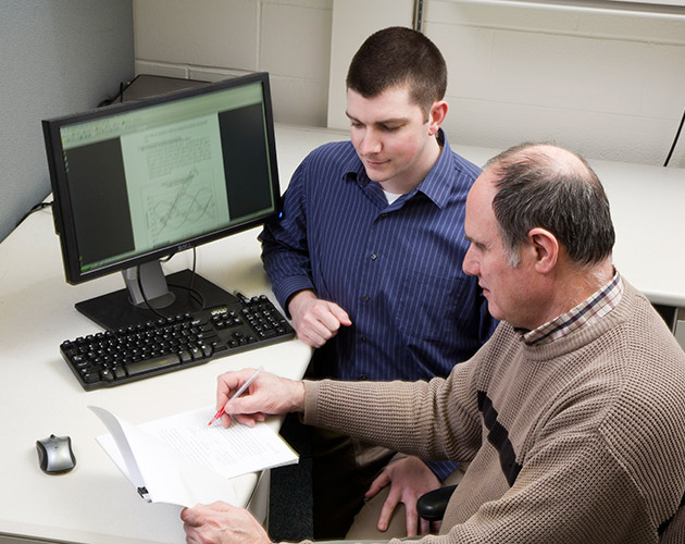 team members working together, working infront of a computer, viewing a synode on computer, synode