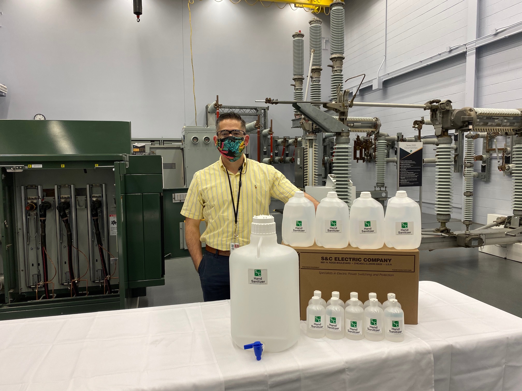 S&C employee in front of donated supplies